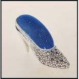 A silver and marcasite contemporary designed VIctorian manner pin cushion in the form of a ladies