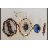 An early 19th century mourning brooch set with turquoise having a central hair locket together