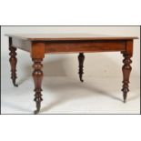 A 19th century Victorian large extending mahogany dining table. The large top with chamfered edge