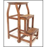 An early 20th Century Arts and Crafts metamorphic folding set of library steps / ladder, the three