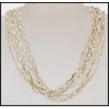 A 20th Century ladies pearl necklace consisting of eight strings with baroque pearls and white metal