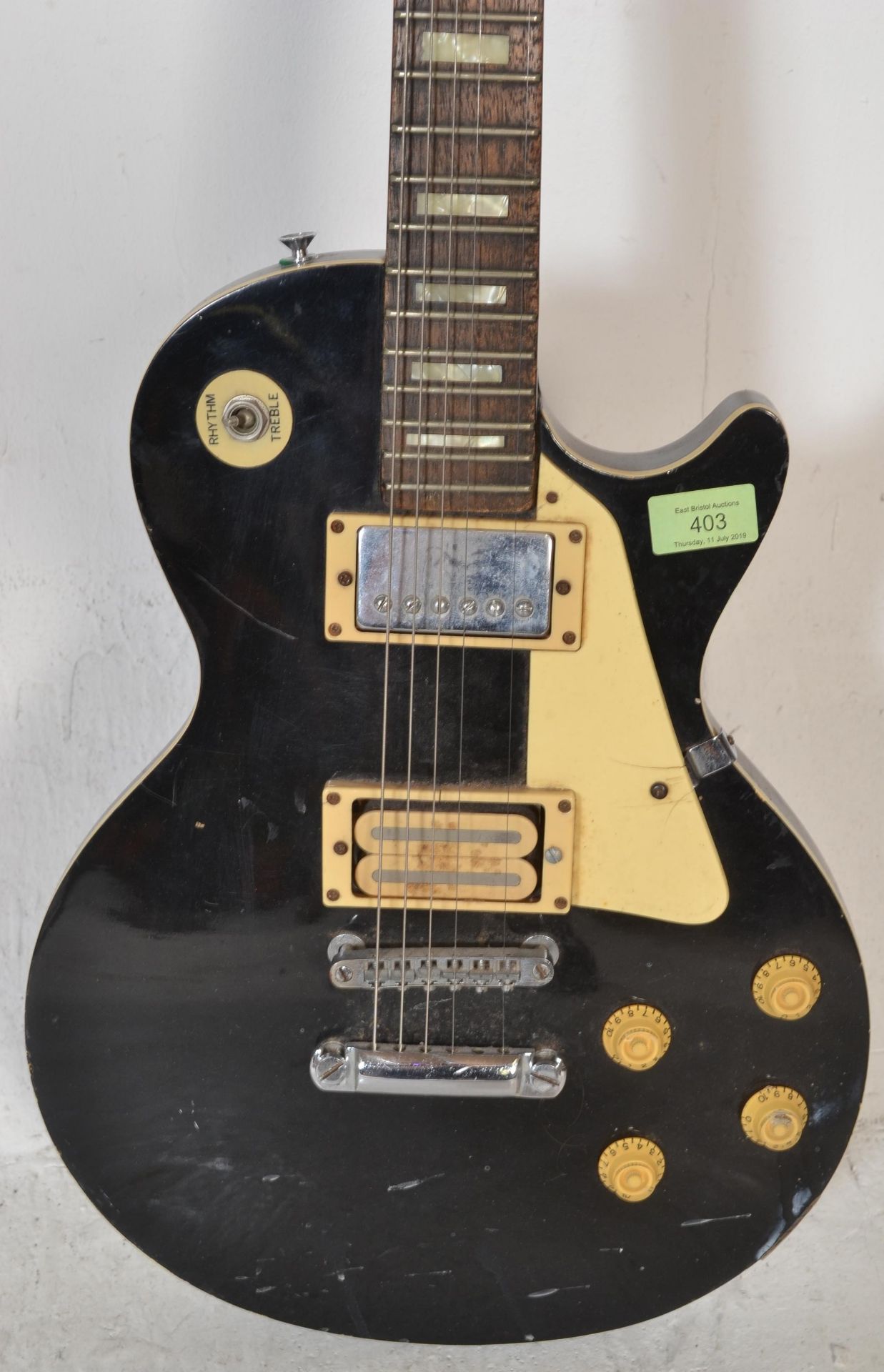 A vintage style  American made Hondo six string electric guitar, having a black body with white - Bild 2 aus 4