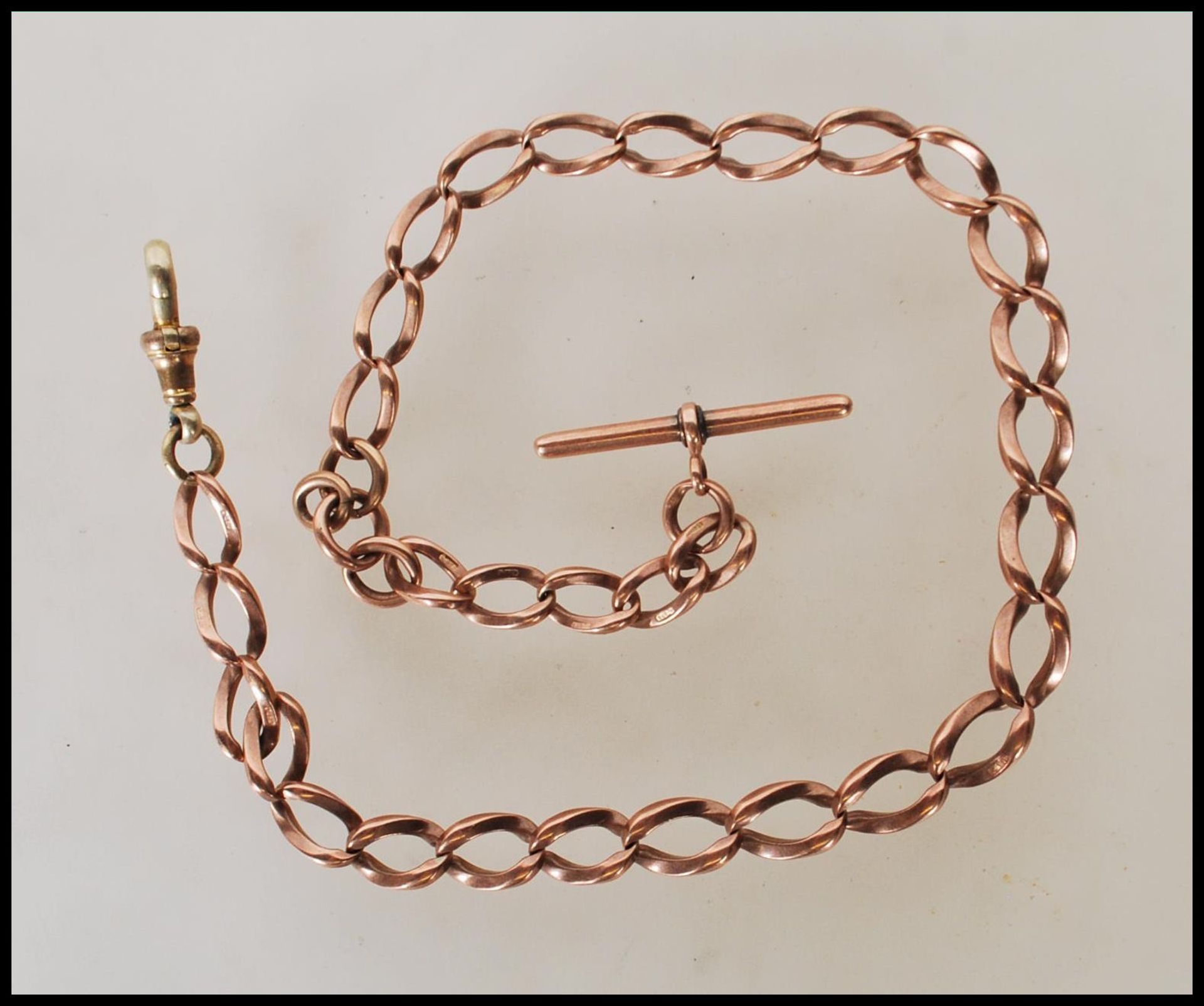 A 9ct gold curb link albert pocket fob watch chain bearing hallmark to every link and T bar, with