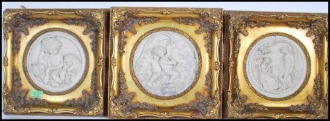 A set of three framed marble composite wall plaque