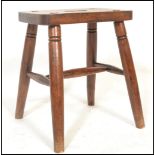 A Victorian 19th century beech and elm country stool. Raised on ring turned legs with a