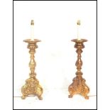 A pair of 20th Century gilt wood carved electric table lamps in the Rococo taste, raised on scrolled