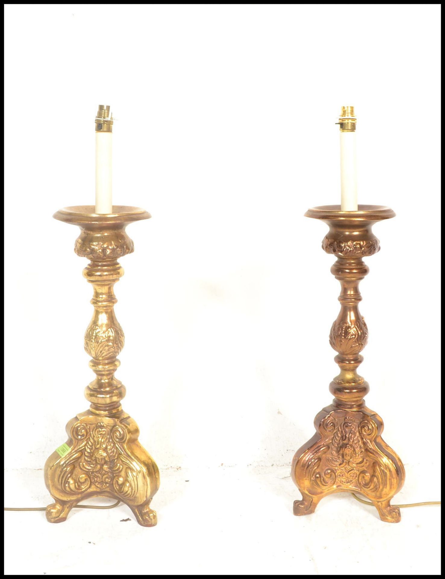A pair of 20th Century gilt wood carved electric table lamps in the Rococo taste, raised on scrolled