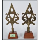 A pair of unusual 20th century trade union banner head brass speak heads. Each raised on mahogany