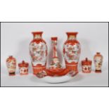A group of early 20th Century Japanese orange Kutani wares having hand painted oriental scene and