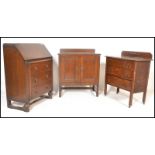 A collection of oak furniture dating the early 20th Century to include a bureau with fall front over