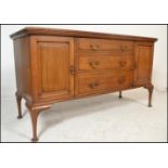 An early 20th Century Edwardian mahogany sideboard credenza by Shoolbred, central bank of three