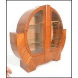 An early 20th Century 1930's Art Deco walnut veneer display cabinet of circular form, having