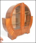 An early 20th Century 1930's Art Deco walnut veneer display cabinet of circular form, having