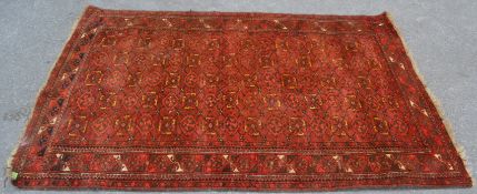 A 19th century Persian / Islamic Bokhara rug with red  ground having geometric decoration to the
