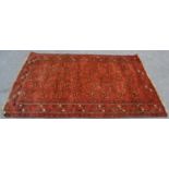 A 19th century Persian / Islamic Bokhara rug with red  ground having geometric decoration to the