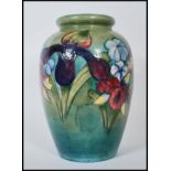 A early Moorcroft vase of bulbous form in the Orchard pattern having tubelined decoration on green