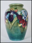 A early Moorcroft vase of bulbous form in the Orchard pattern having tubelined decoration on green