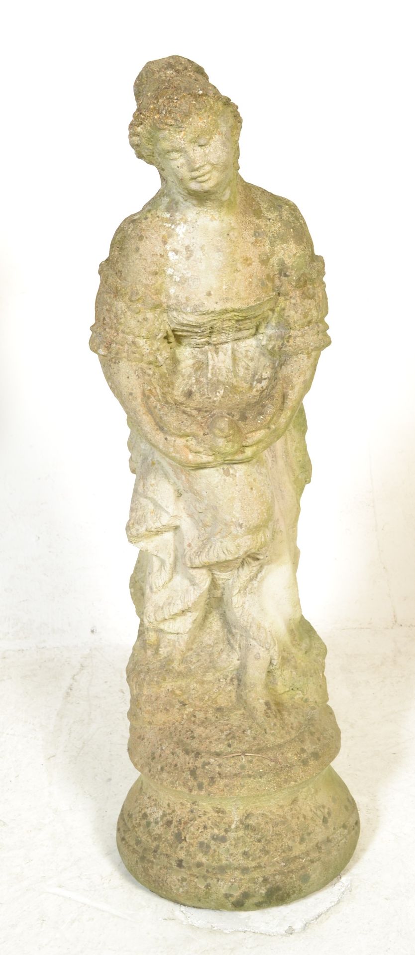 A 20th century well weathered classical garden statue of a maiden on plinth base being constructed