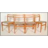 A set of 4 20th Century retro beech wood rail back dining chairs having a beech frame with check