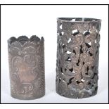 Two silver hallmarked cup / beaker holders to include a repousse effect holder with scrolled rim and