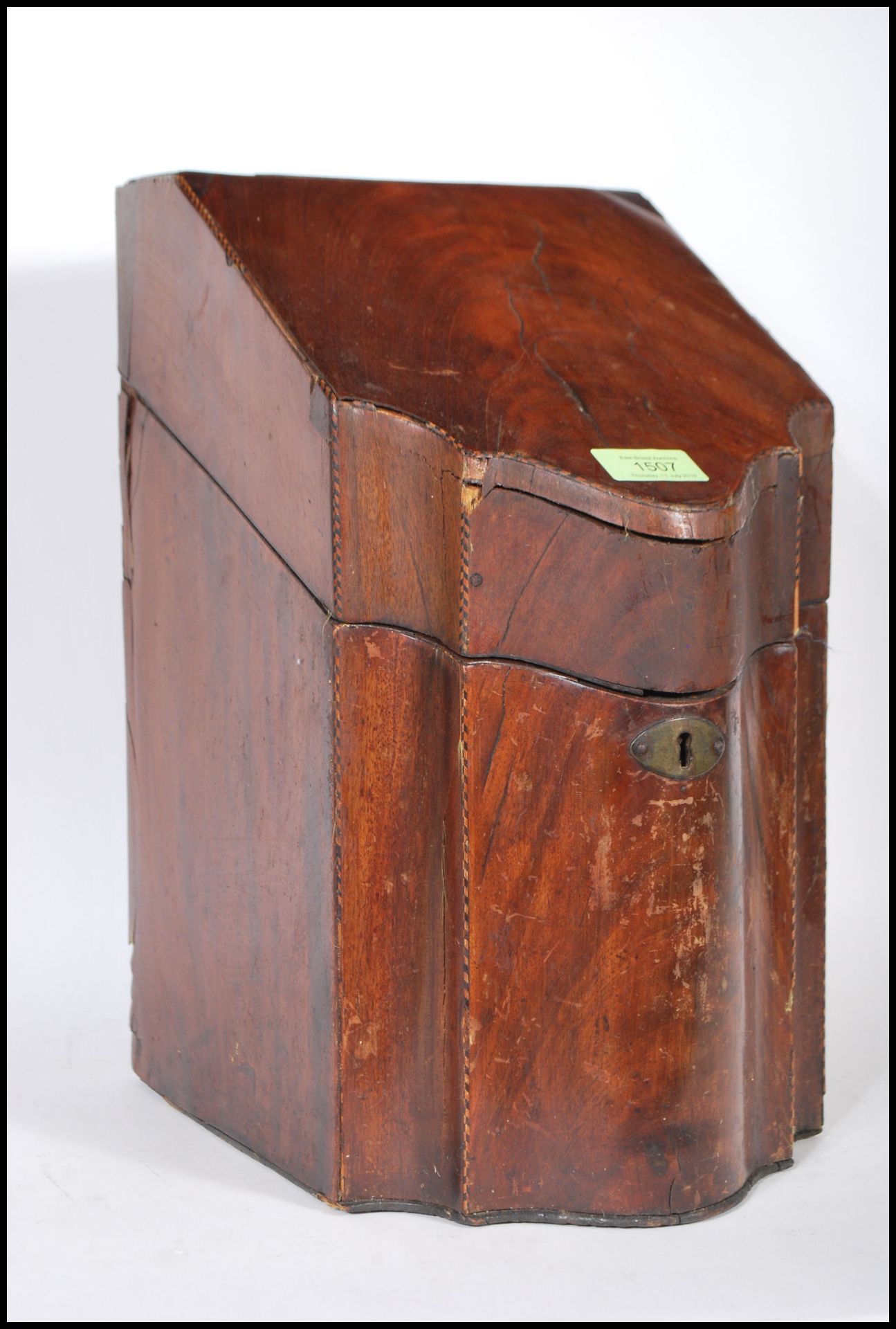 An 18th century George III mahogany inlaid knife box - cutlery box. Of serpentine form with hinged