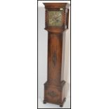 A 19th century carved oak grandmother clock. The trunk with geometric carved embellishments, the