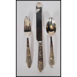 A Chinese silver singular cutlery set consisting on a knife, fork and spoon having floral decoration