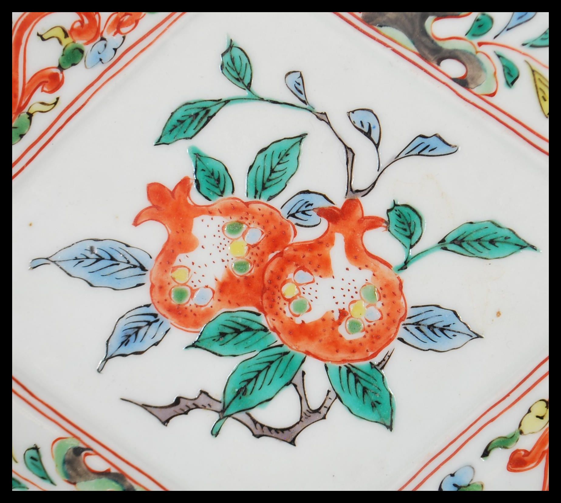 A 19th century Chinese Wucai dish of lozenge form being handpainted with fruit tree cartouche - Image 2 of 4