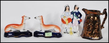 A group of 19th Century Staffordshire ceramics to include two greyhound quill holders hand painted