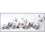 A Royal Albert coffee service in the Masquerade pattern comprising of cups, saucers, side plates,