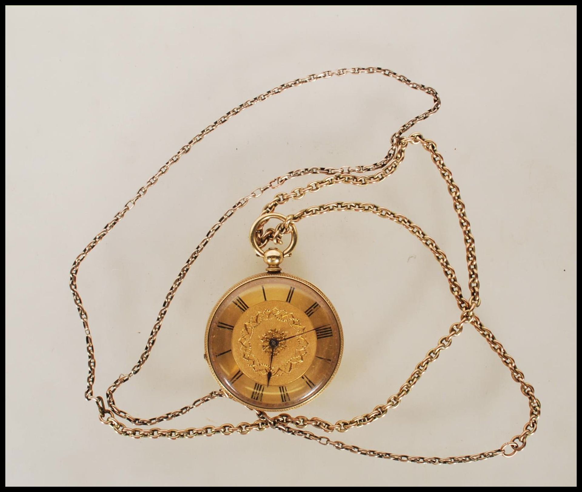 A vintage 18ct gold open faced pocket watch having a gilt face with roman numerals to the chapter