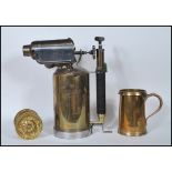 A Georgian 19th Century brass tankard / measure of large form having shaped handle and impressed