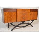 A mid 20th Century teak wood sideboard / credenza, central bank of three drawers flanked by