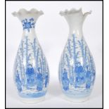 A pair of Japanese porcelain blue and white vases having flared and fanned rims with transfer