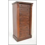 A 19th century Victorian Wellington pedestal chest of drawers being raised on plinth base with a