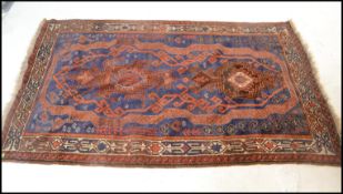 A 19th century Persian / Islamic Tabriz rug with red and blue ground having geometric decorated