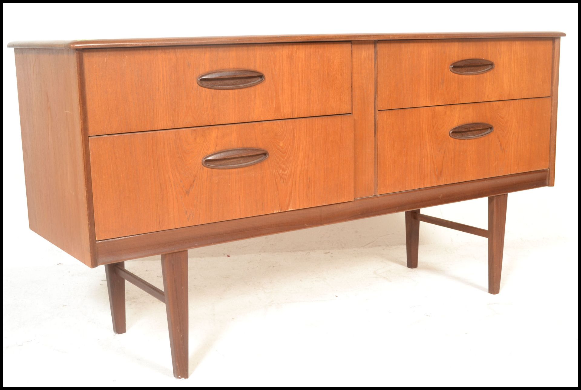 A retro 20th Century teak wood Danish inspired sideboard / credenza, having a twin bank of drawers