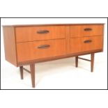 A retro 20th Century teak wood Danish inspired sideboard / credenza, having a twin bank of drawers