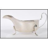 A Viner's silver hallmarked sauce boat having a shaped rim raised on cab feet. Hallmarked