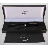 A Mont Blanc Meisterstuck fountain pen in a black colourway with gilt details having a 14ct gold