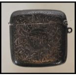 A early 20th Century silver hallmarked vesta case having engraved foliate and swirl decoration