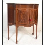 An Edwardian mahogany inlaid serpentine fronted side cabinet / work table. The hinged top with