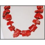 A vintage coral necklace consisting of threaded coral pieces with red bead spacers and stamped 925