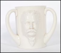 A 19th Century W.H. Goss large triple handled loving cup in relief featuring the bust of W.H.