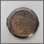 A vintage silver hallmarked Kigu compact of round form having a bark effect exterior and mirror to