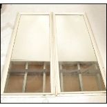 A pair  vintage early 20th century shop / haberdashery mirrors. Of rectangular form having white