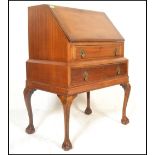 A 20th Century 1930's mahogany bureau writing desk. Raised on cabriole legs with ball and claw