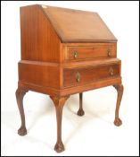 A 20th Century 1930's mahogany bureau writing desk. Raised on cabriole legs with ball and claw