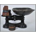 Vintage traditional balance weighing scales. Cast iron with copper bowl plus eleven weights.
