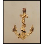 A 9ct gold pendant in the form of an anchor with a